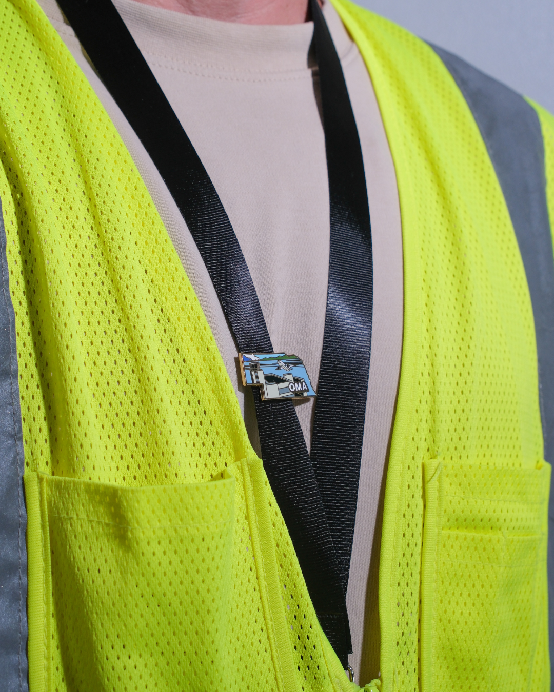 OMA airport pin for Eppley Airfield, attached to a black lanyard.