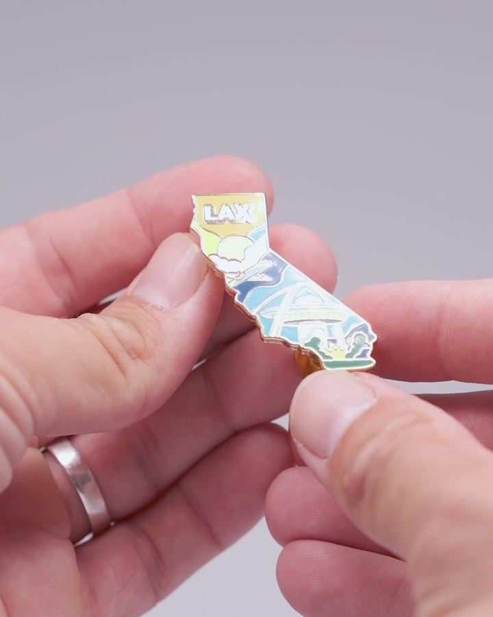 Close-up video of the LAX Aviation Pin, a 1.5-inch hard enamel pin shaped like California, featuring engraved details, dual pin and magnet function, and premium packaging.